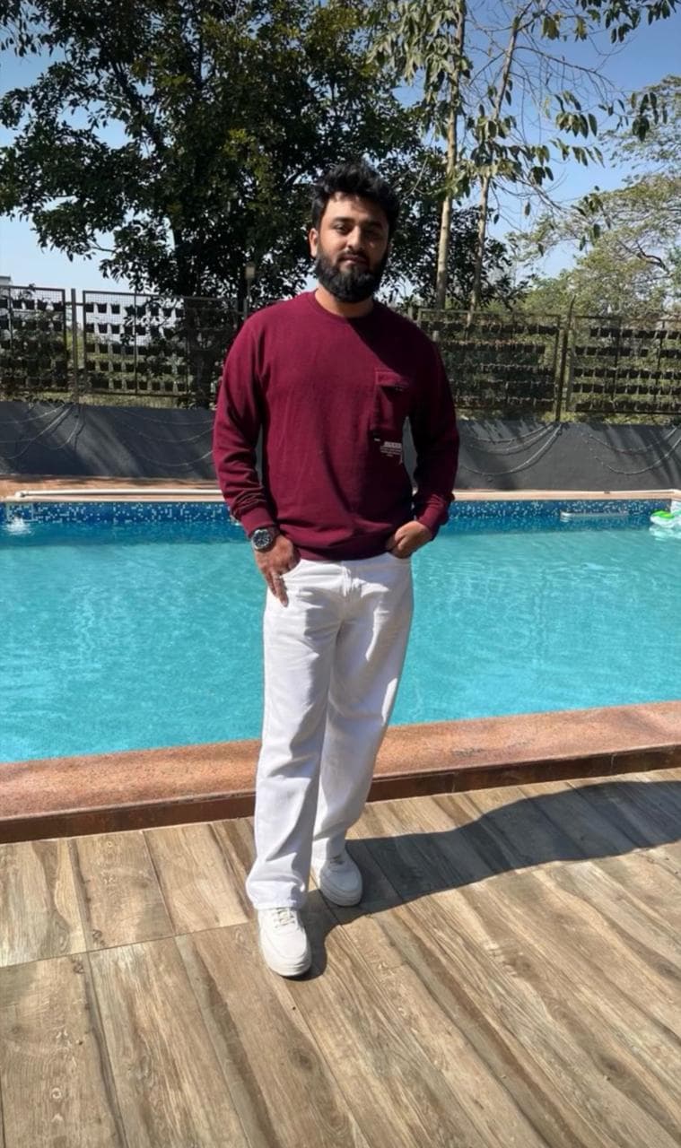 After: client in a burgundy top and white trousers, standing beside a swimming pool.