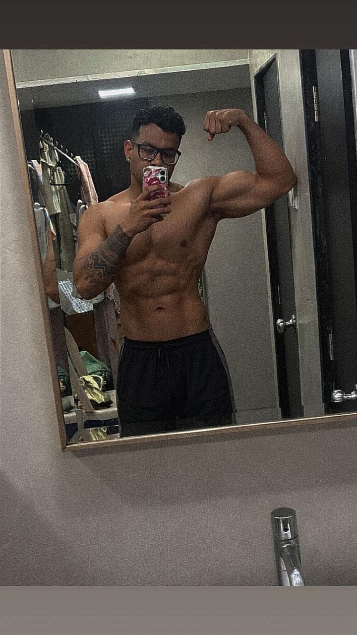 After: client wearing black shorts and glasses, flexing an arm in a mirror photo.